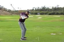 Golf instructor demonstrating swing technique during Ultimate Golf Mastery Pro instructors review